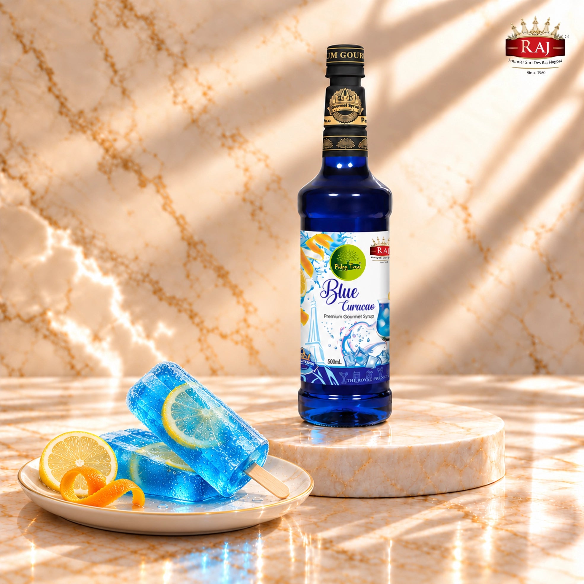 RAJ Pulpy Tree Blue Curacao syrup bottle beside blue citrus popsicles with lemon slices frozen inside.