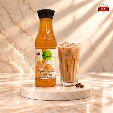 RAJ Pulpy Tree Butterscotch Crush bottle beside iced cold coffee with a butterscotch twist
