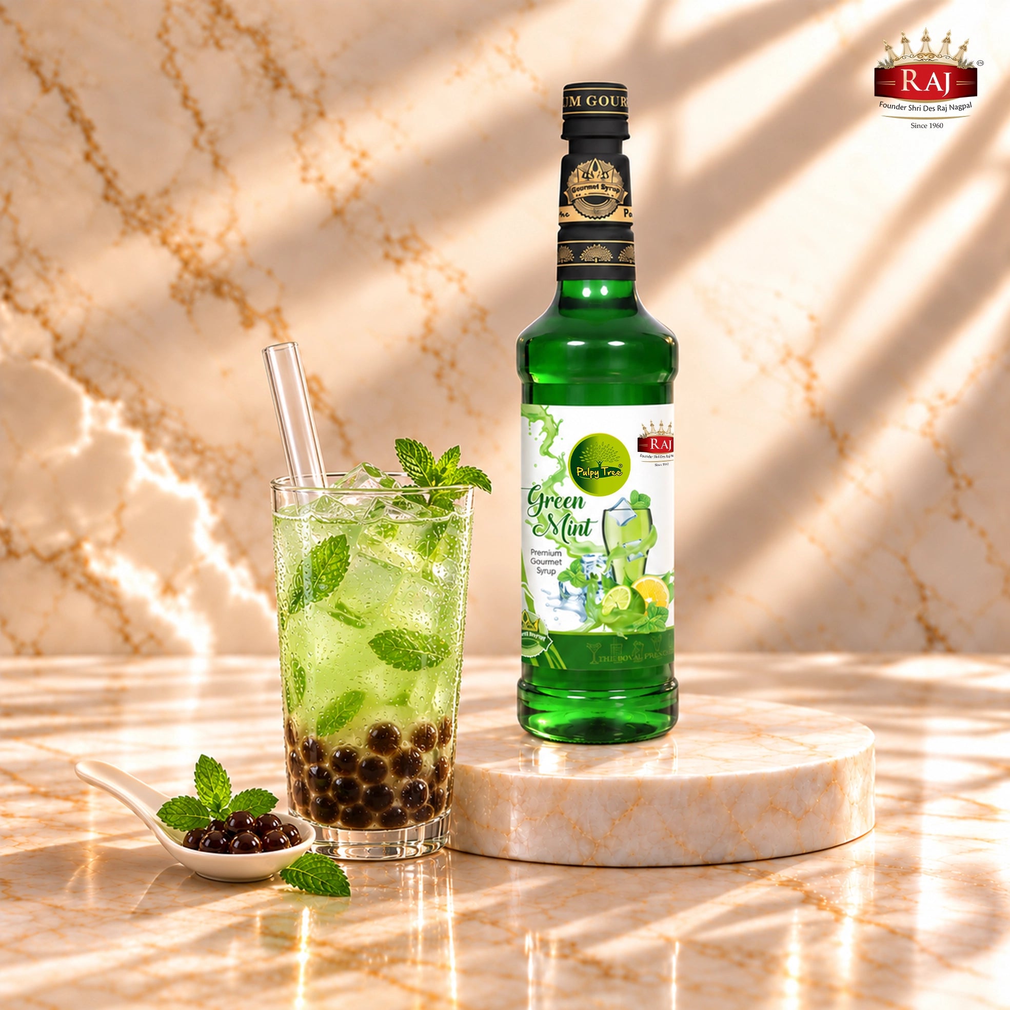 RAJ Pulpy Tree Green Mint syrup bottle beside mint bubble tea with tapioca pearls, ice and a wide straw.