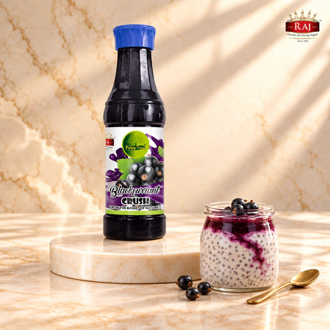 Blackcurrant Crush bottle beside chia pudding with a blackcurrant swirl and berries