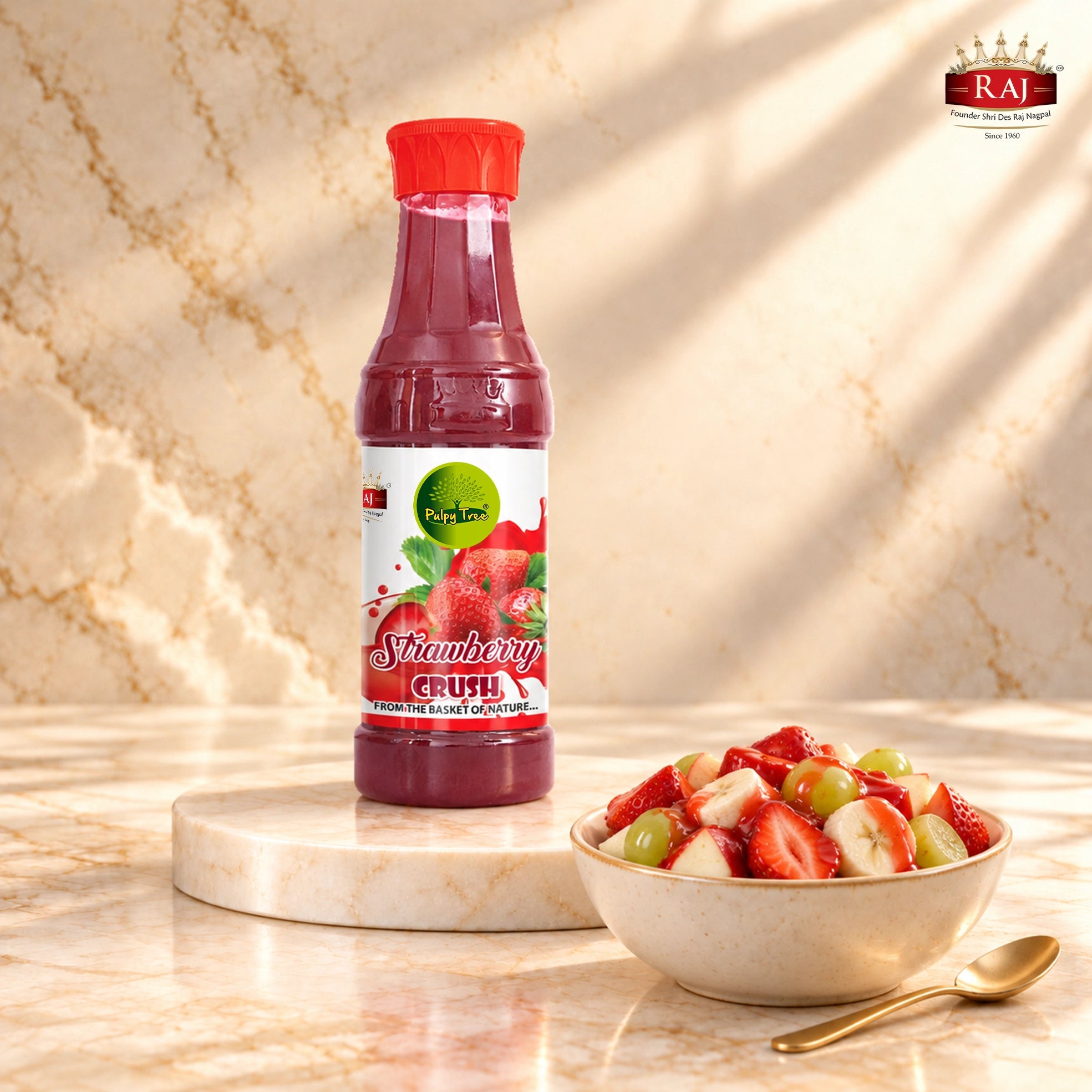 Strawberry Crush bottle beside a fruit salad with apple, banana, grapes and strawberry drizzle