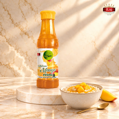 RAJ Mango Crush bottle beside breakfast oats topped with mango drizzle and fresh mango cubes