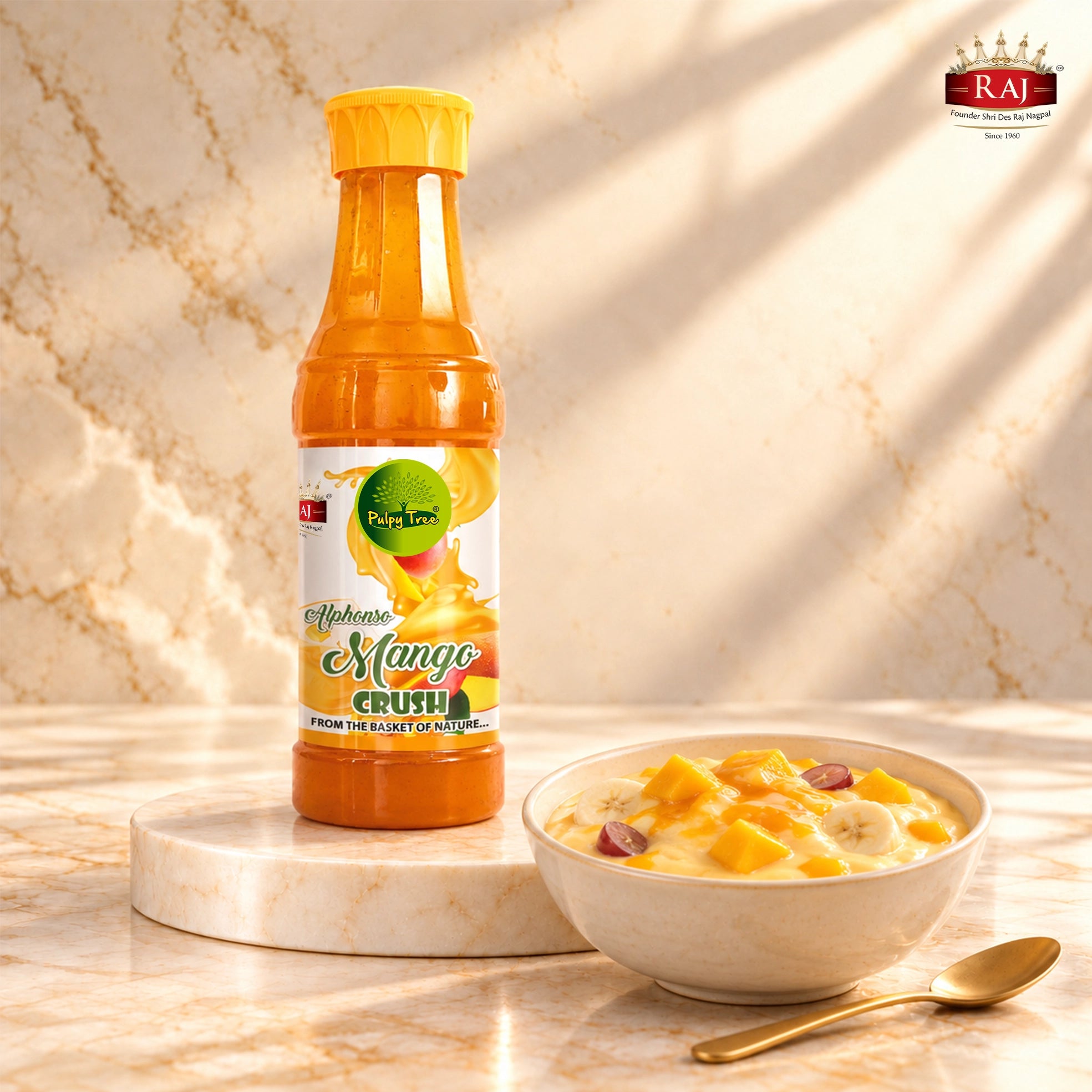 RAJ Mango Crush bottle beside fruit custard with mango drizzle, banana and grapes