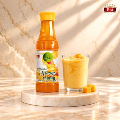 RAJ Mango Crush bottle beside a glass of mango lassi topped with mango pieces