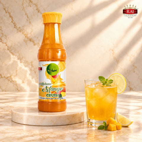 RAJ Mango Crush bottle beside iced mango lemonade garnished with lemon and mint