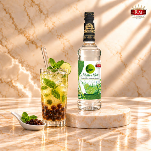 RAJ Pulpy Tree Mojito Mint syrup bottle beside iced mint bubble tea with tapioca pearls and a wide straw.