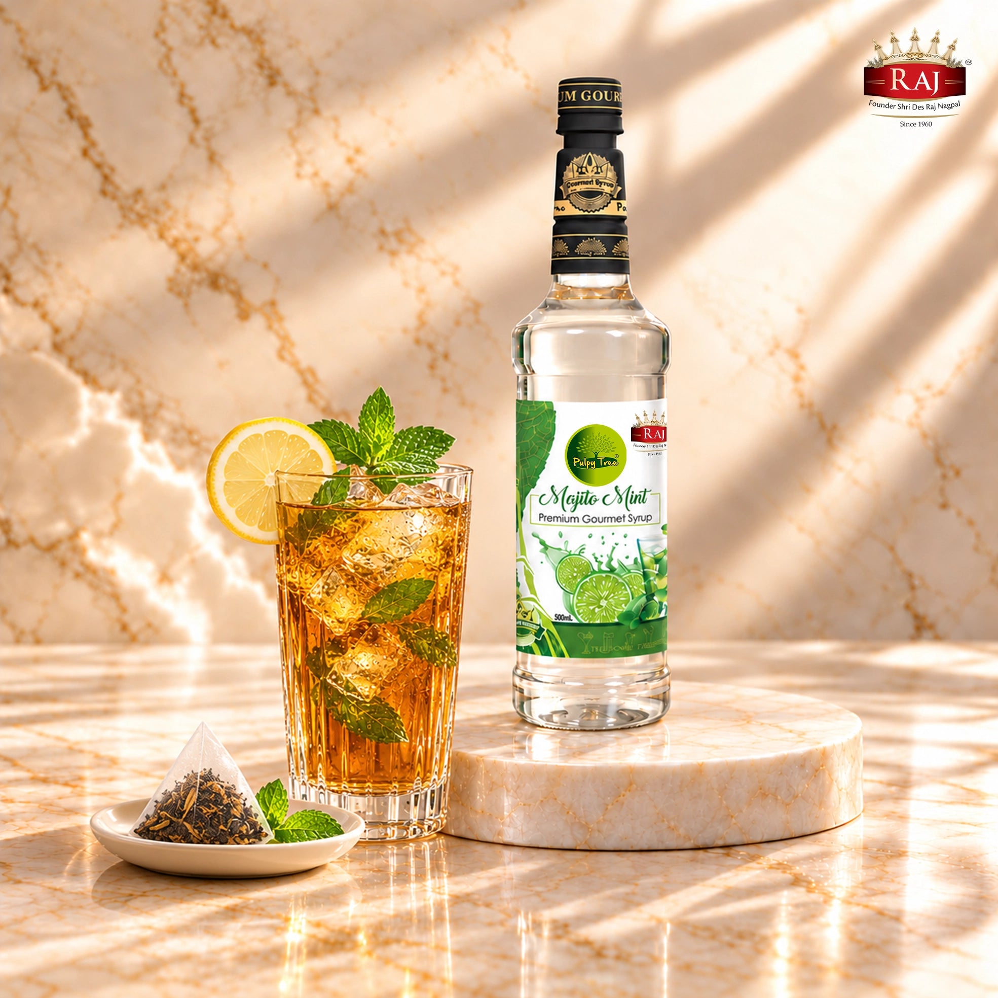 RAJ Pulpy Tree Mojito Mint syrup bottle beside amber mint iced tea with lemon, ice and a tea sachet.