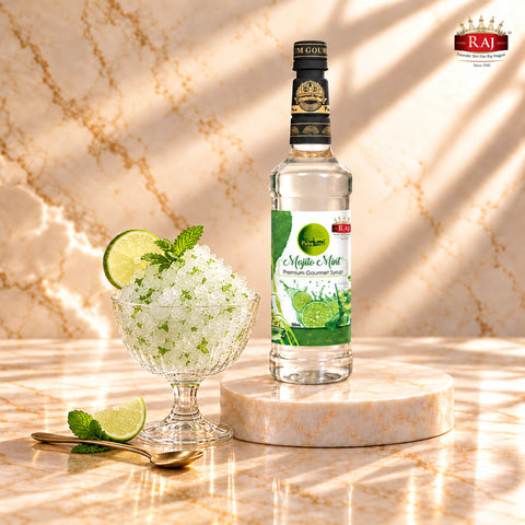 RAJ Pulpy Tree Mojito Mint syrup bottle beside a frozen mint lime slush garnished with mint and lime.