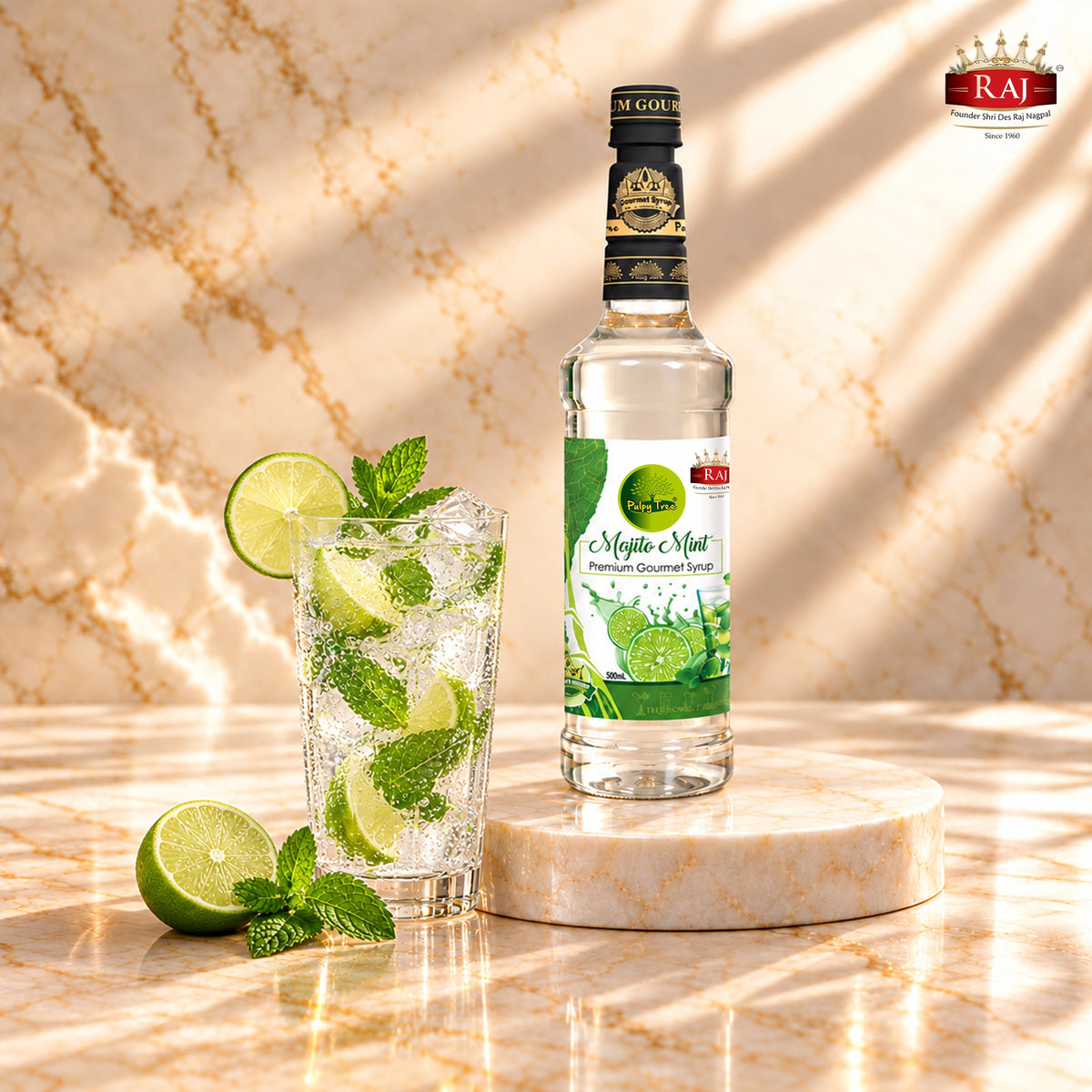 RAJ Pulpy Tree Mojito Mint syrup bottle beside a virgin mojito with fresh lime, mint and ice.