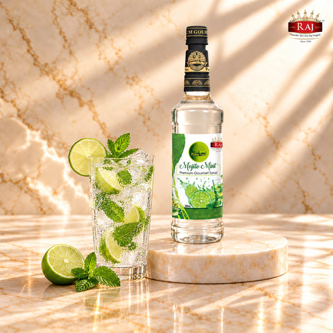 RAJ Pulpy Tree Mojito Mint syrup bottle beside a virgin mojito with fresh lime, mint and ice.