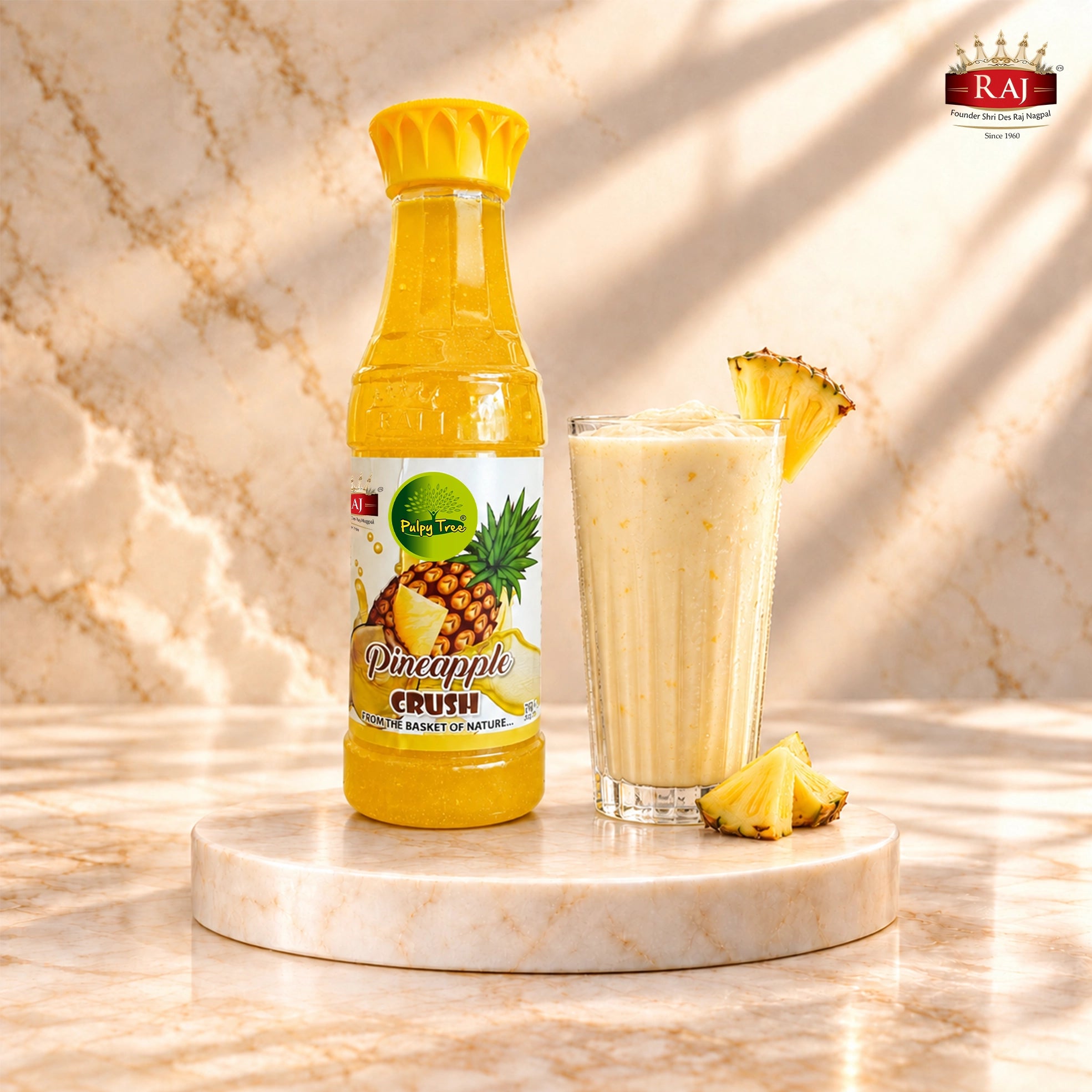 RAJ Pulpy Tree Pineapple Crush bottle beside a pineapple milkshake and fresh pineapple pieces