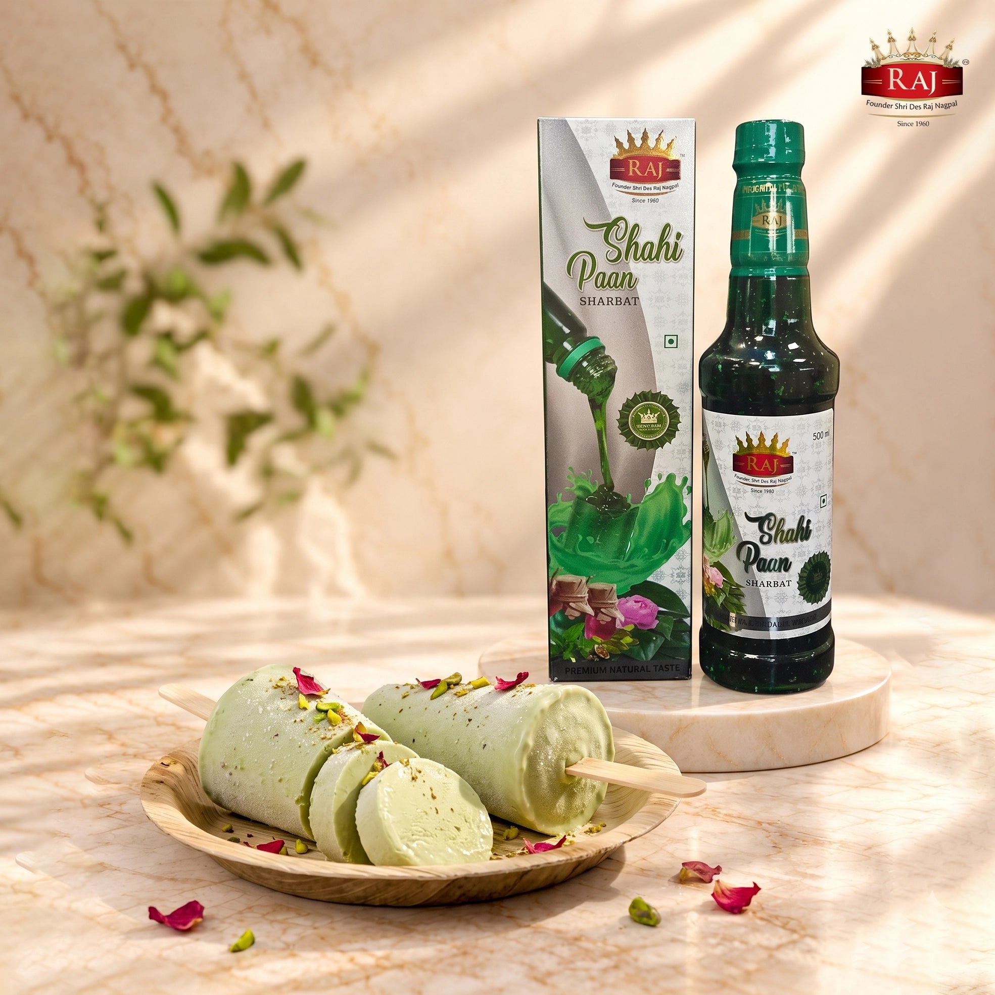 Traditional Shahi Paan Kulfi garnished with pistachios and rose petals beside RAJ Shahi Paan Sharbat 500 ml bottle and carton