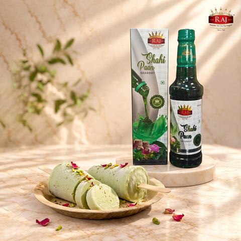 Traditional Shahi Paan Kulfi garnished with pistachios and rose petals beside RAJ Shahi Paan Sharbat 500 ml bottle and carton